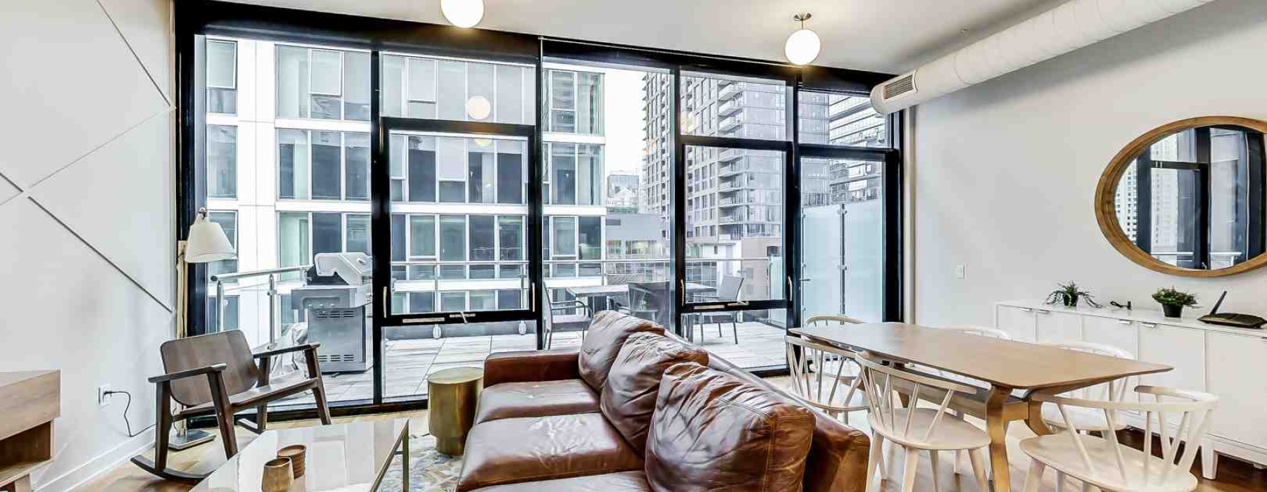Open concept studio apartment layout with large windows