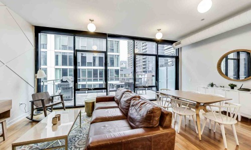 Open concept studio apartment layout with large windows