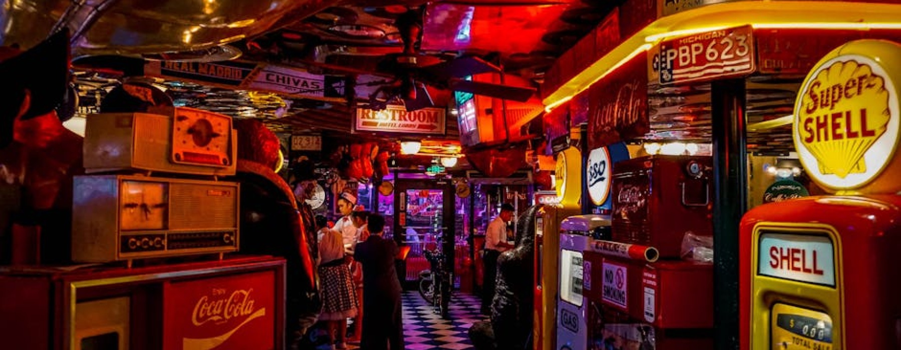 Neon arcade bar signs in Chicago with people playing vintage games - arcade bar chicago